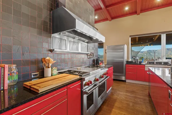 a kitchen with stainless steel appliances granite countertop a stove and a wooden cabinets