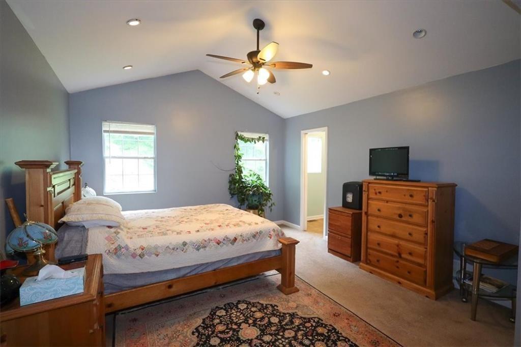 236 Hiram Sudie Road Dallas, GA 30157 - Photo 12 of 26 a bedroom with a bed and a chandelier