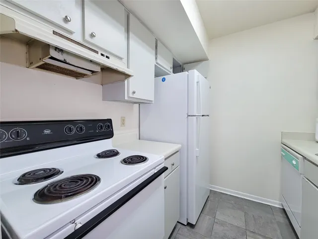 a kitchen with a stove and a refrigerator