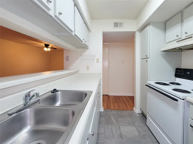 a kitchen with a sink and a stove top oven