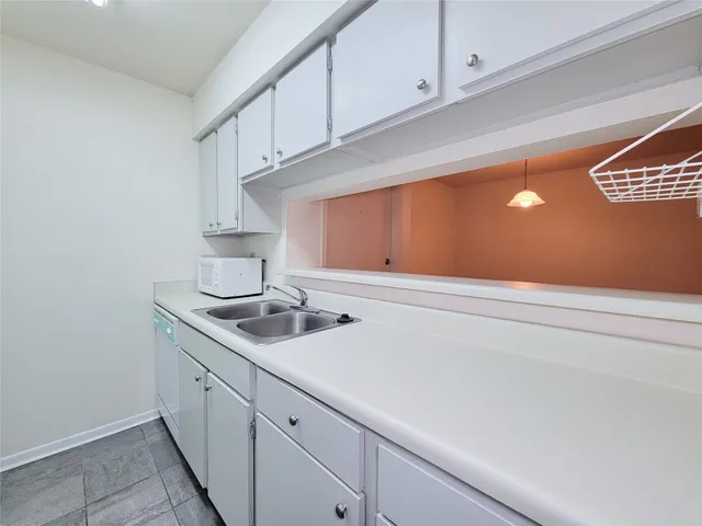 a kitchen with a sink and cabinets