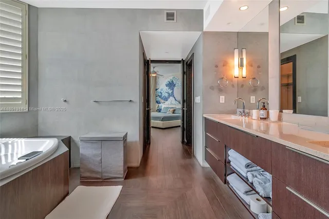 a bathroom with a bathtub a sink and a window