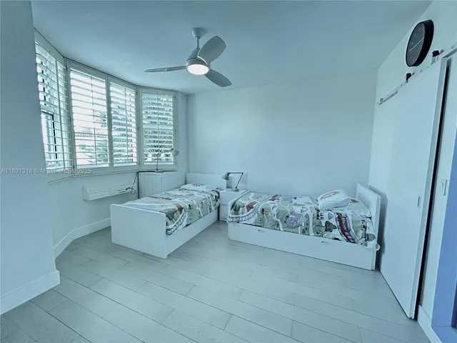 a spacious bedroom with a bed and a window