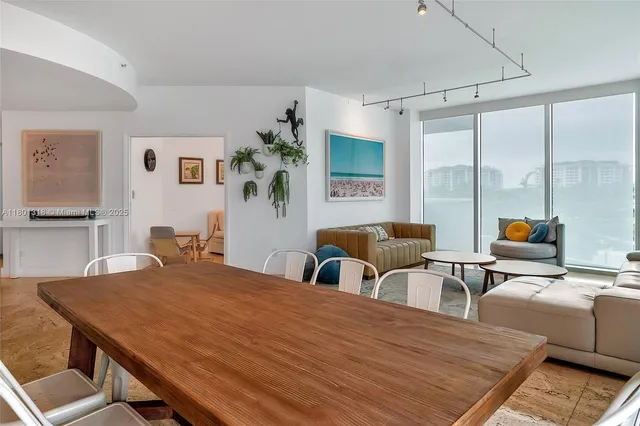 a living room with furniture and large window