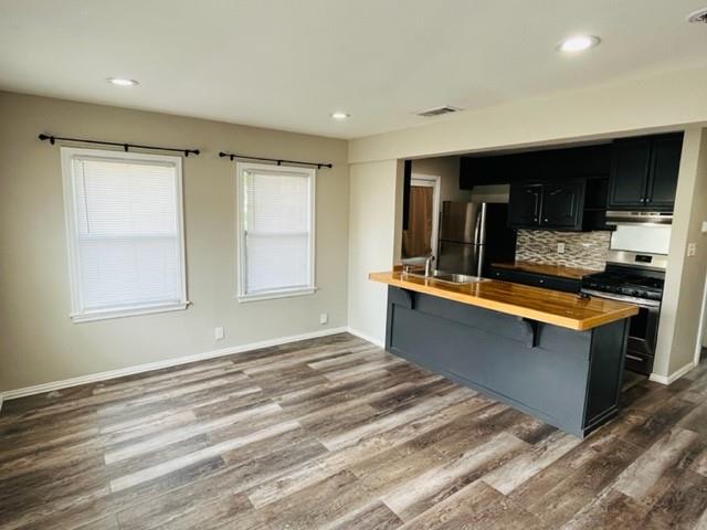 4000 Walker Street Dallas, TX 75211 - Photo 2 of 8 a spacious bathroom with a granite countertop sink and a large mirror