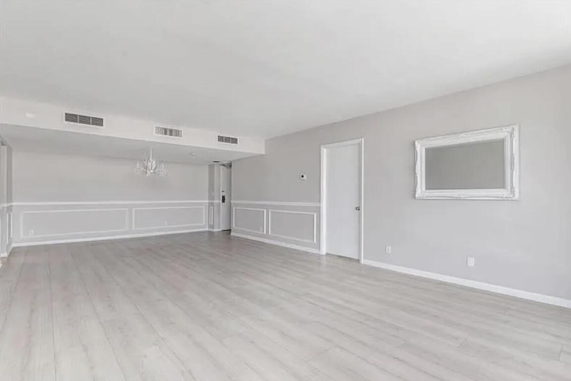 3800 Washington Road, Unit 310 West Palm Beach, FL 33405 - Photo 8 of 14 a view of an empty room with wooden floor