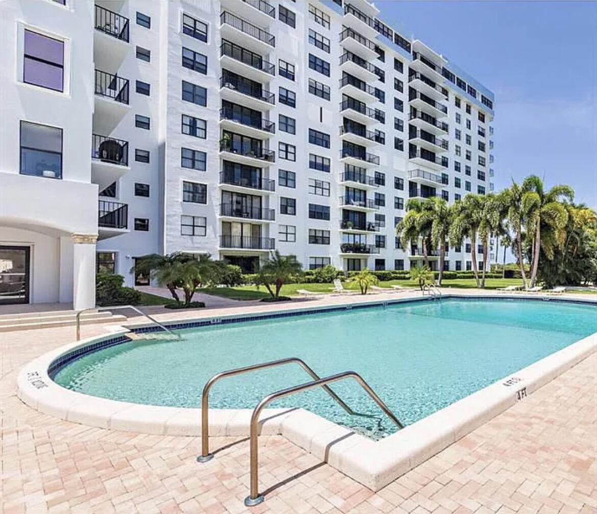 3800 Washington Road, Unit 310 West Palm Beach, FL 33405 - Photo 10 of 14 a view of a swimming pool with a lounge chairs