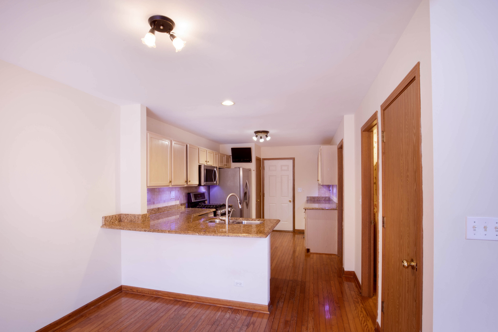 4736 Lacey Avenue Lisle, IL 60532 - Photo 3 of 20 a view of living room with stainless steel appliances granite countertop furniture and a flat screen tv