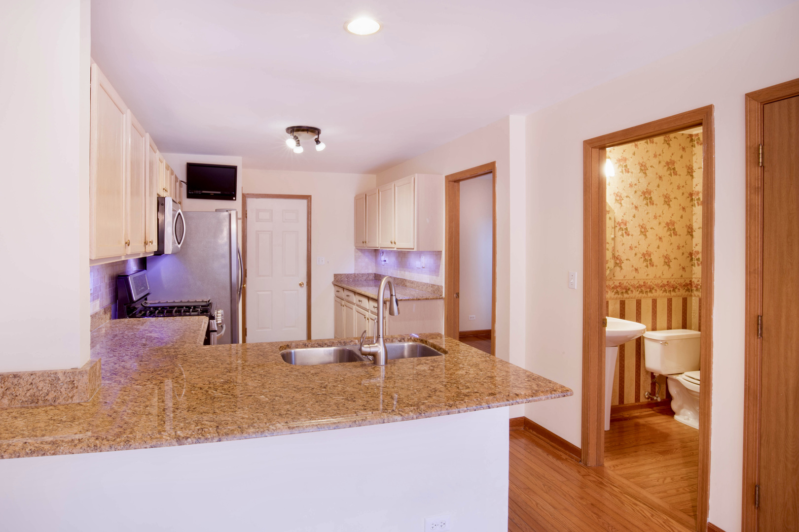 4736 Lacey Avenue Lisle, IL 60532 - Photo 4 of 20 a kitchen with kitchen island granite countertop a sink and a refrigerator