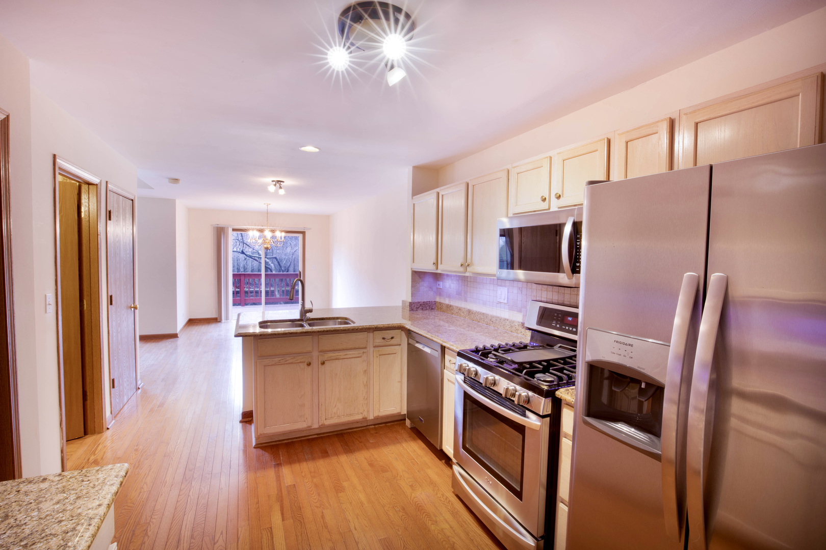 4736 Lacey Avenue Lisle, IL 60532 - Photo 5 of 20 a kitchen with stainless steel appliances granite countertop a refrigerator a stove and a sink with wooden floor