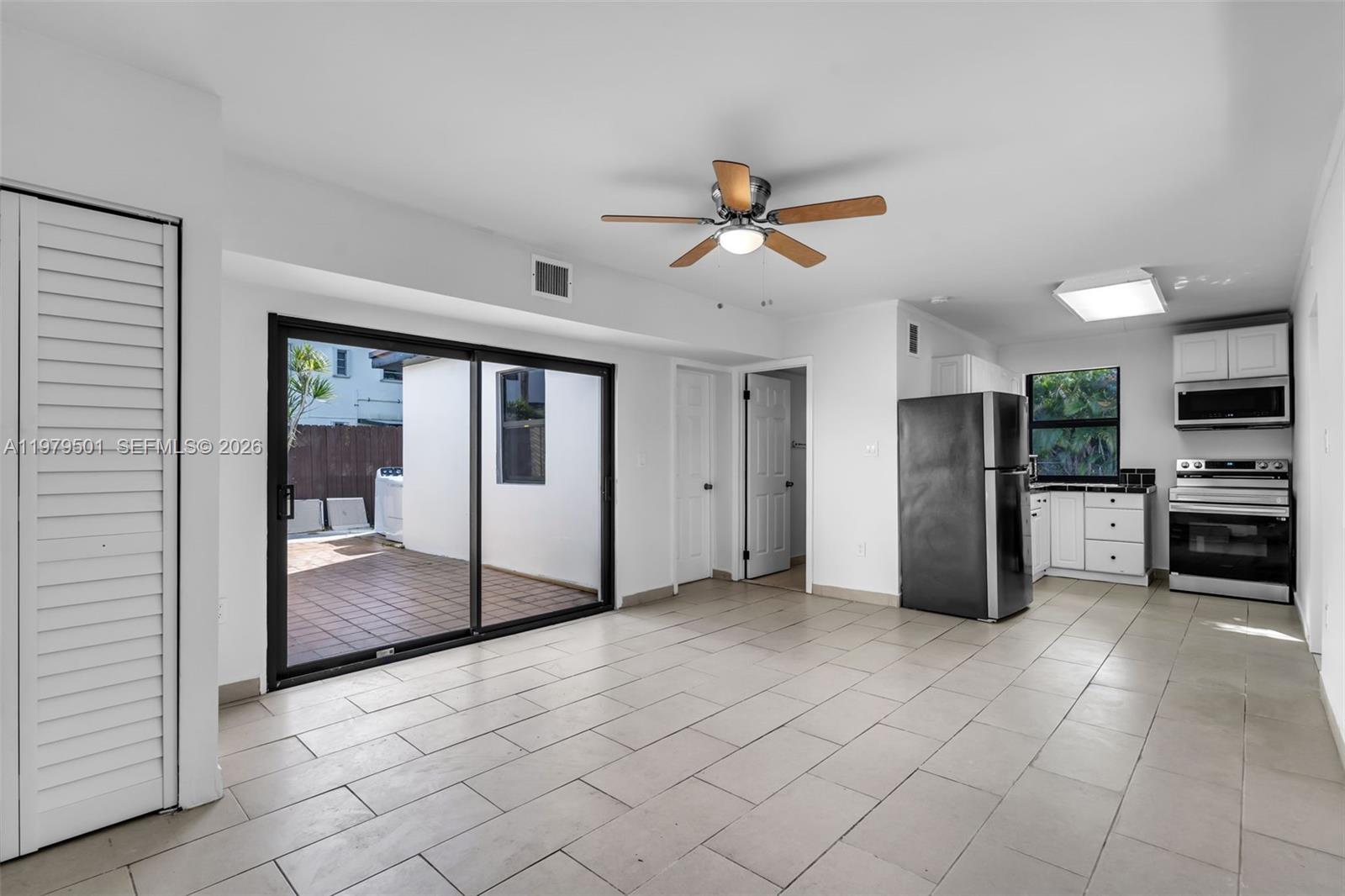 130 Southwest 31st Court, Unit 2 Miami, FL 33135 - Photo 5 of 14 a view of a electric appliances in kitchen and empty room with wooden floor