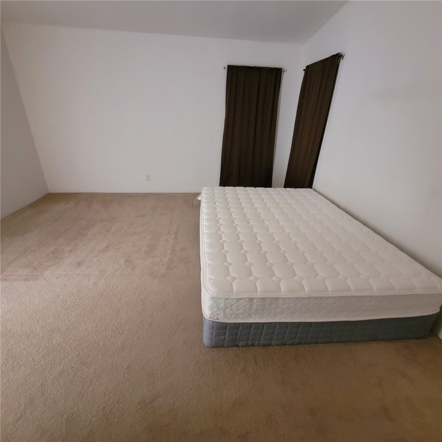 9732 2nd Street Chloride, AZ 86431 - Photo 20 of 28 This room offers a neutral color palette with white walls and light-colored carpet flooring