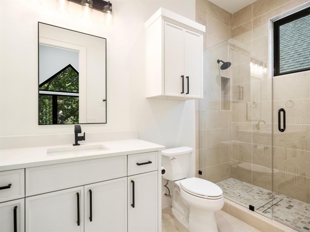 4010 Sperry Street Dallas, TX 75214 - Photo 23 of 40 Full bathroom with a shower stall, vanity, and light tile patterned floors