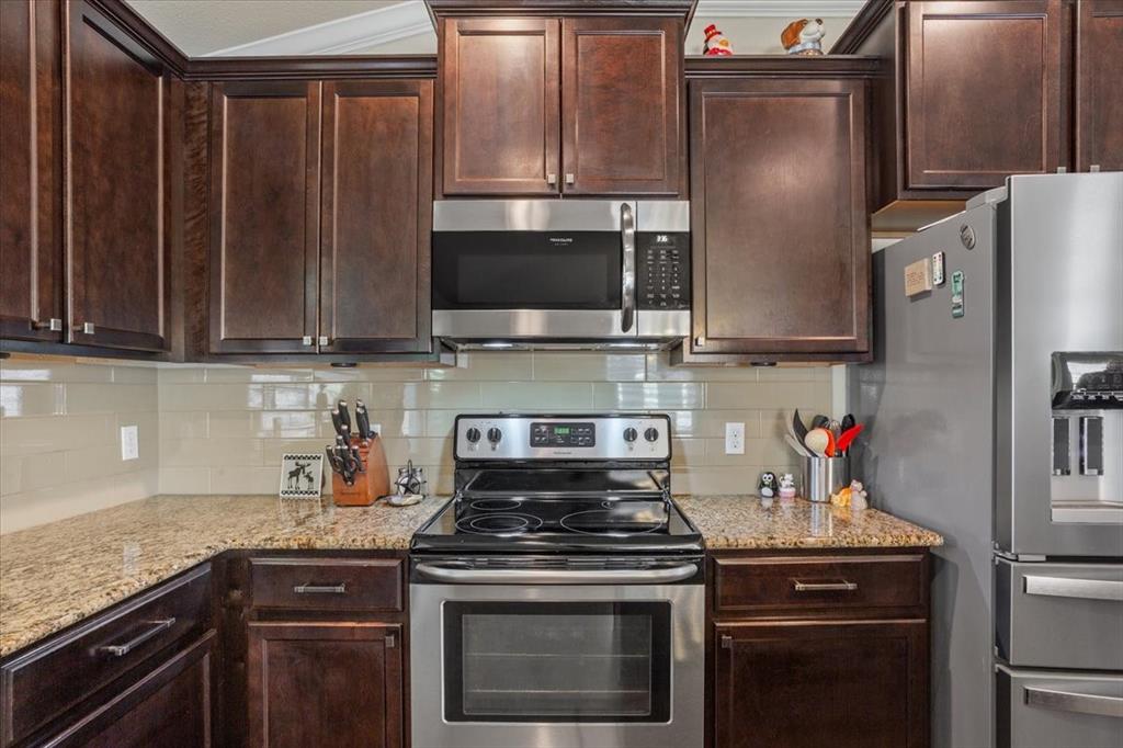 5308 Tama Drive Waco, TX 76708 - Photo 14 of 29 a kitchen with stainless steel appliances granite countertop a stove a refrigerator and a microwave