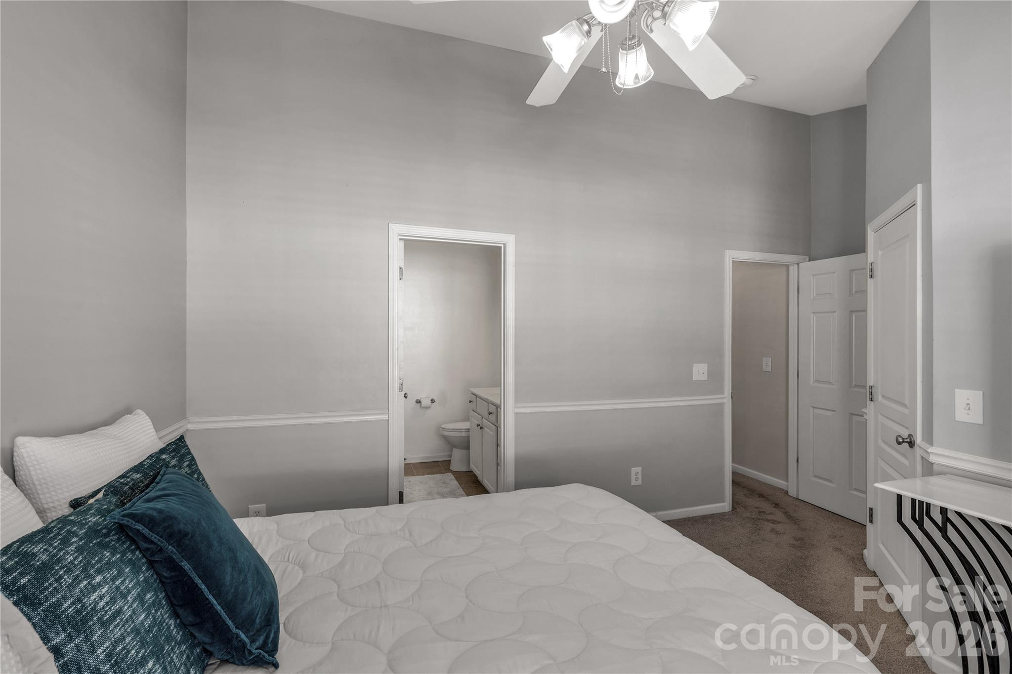 960 Copperstone Lane Fort Mill, SC 29708 - Photo 16 of 29 a bedroom with a bed and a chandelier