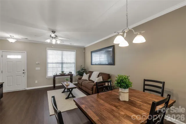 a living room with furniture a chandelier and a window