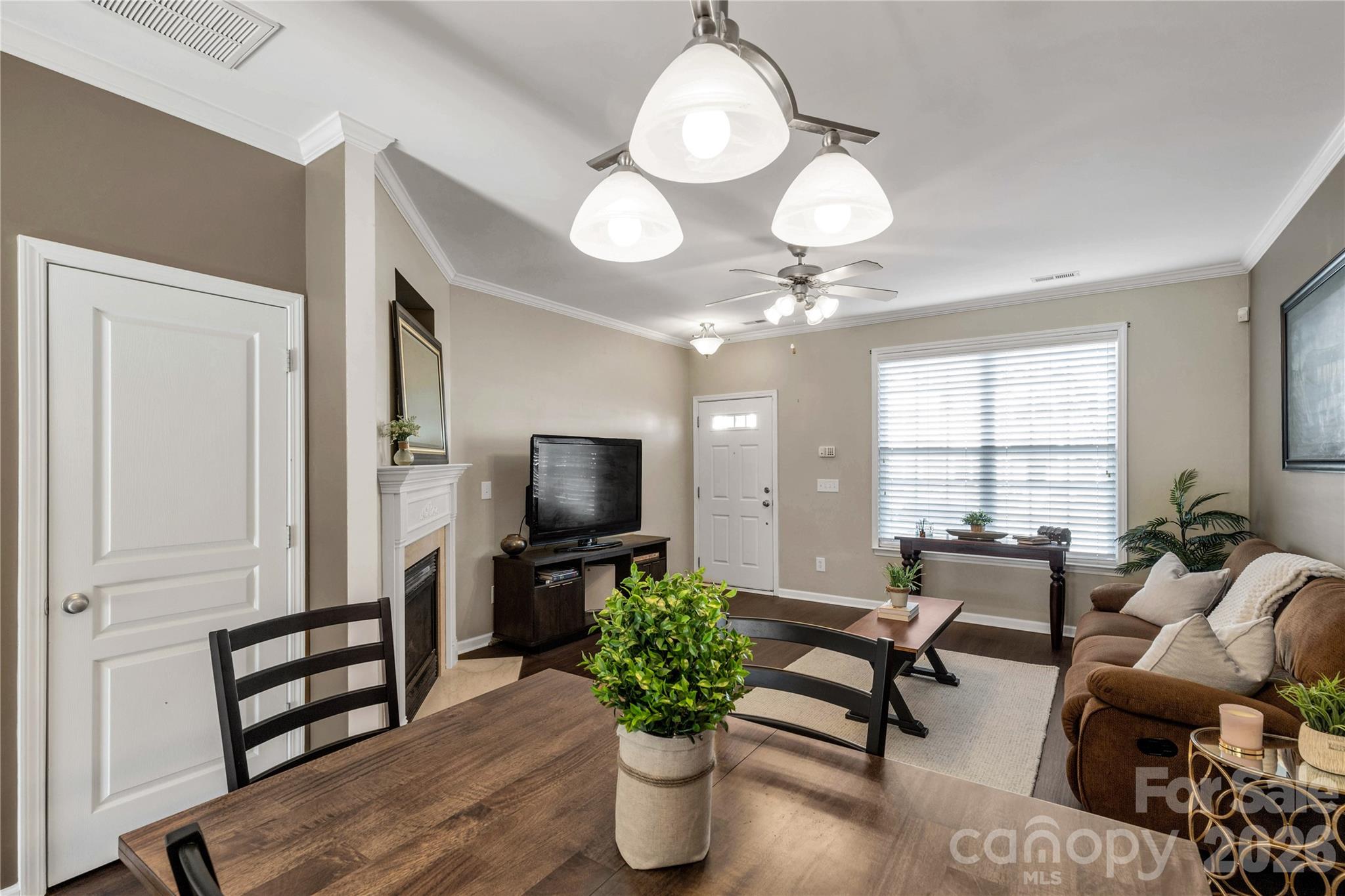 960 Copperstone Lane Fort Mill, SC 29708 - Photo 9 of 29 a living room with furniture a chandelier and a flat screen tv