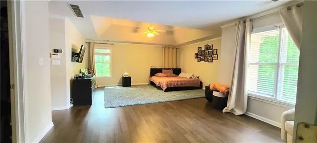 a bedroom with furniture and a wooden floor