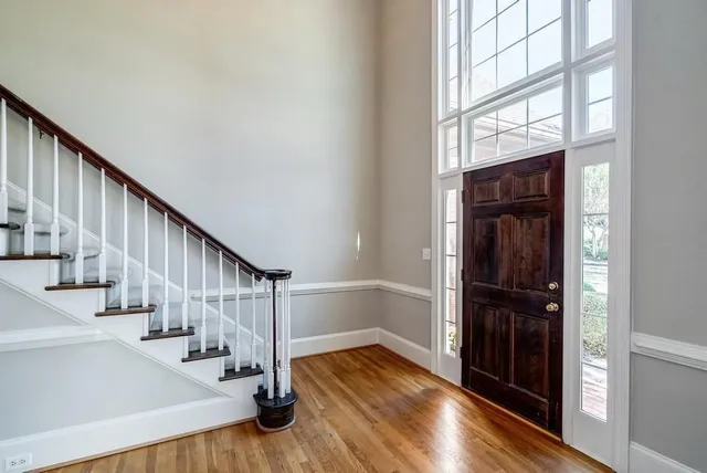 a view of entryway with wooden floor and stairs