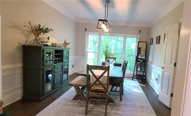 a dining room with furniture a chandelier and window