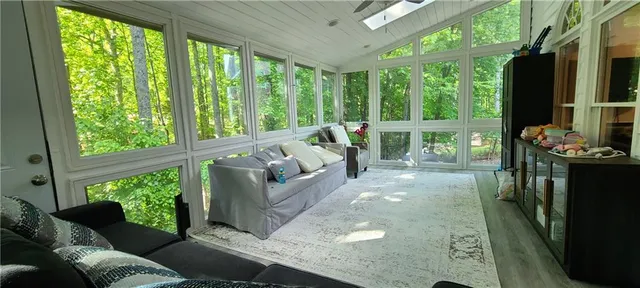 a living room filled with furniture and a large window