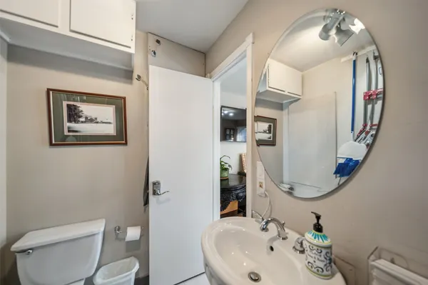 a bathroom with a toilet sink and mirror