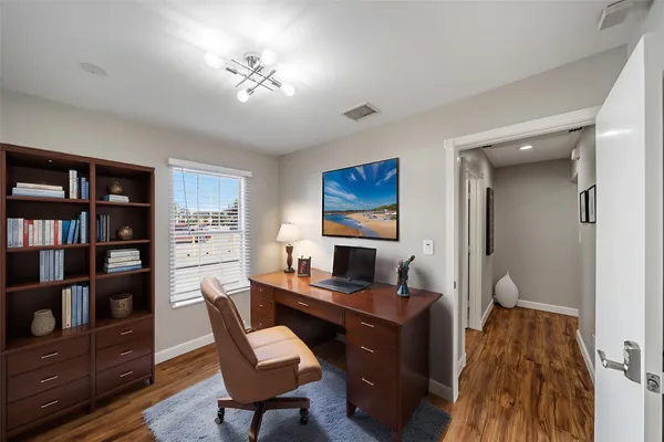 a view of a workspace with furniture and a bookshelf