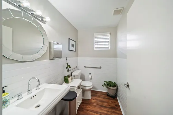 a bathroom with a sink mirror and toilet