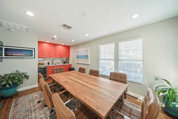 a living room with dining room and wooden floor