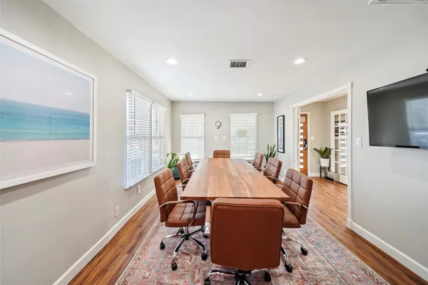 a view of a dining room with furniture window and wooden floor