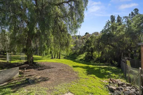 a view of a house with backyard and sitting area