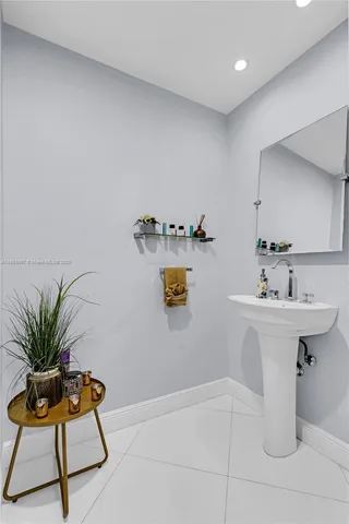 a bathroom with a sink a mirror and vanity