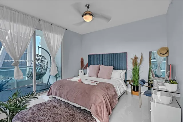 a bedroom with bed and a chandelier