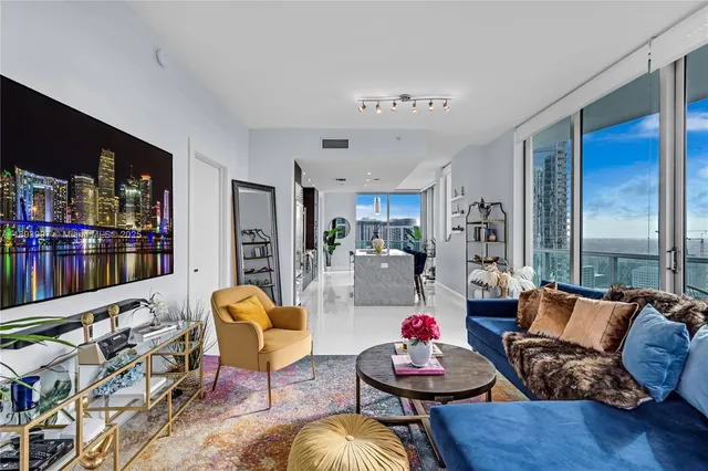 a living room with furniture kitchen and a bookshelf
