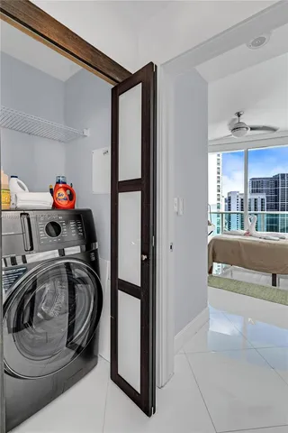 a utility room with sink dryer and washer