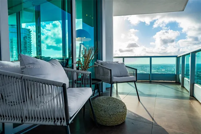 a view of a porch with furniture and garden