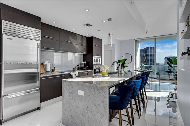 a kitchen with a sink stainless steel appliances and cabinets