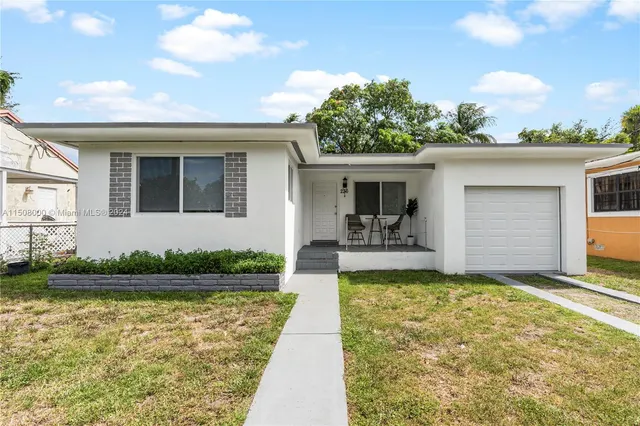 a view of a house with swimming pool and a yard
