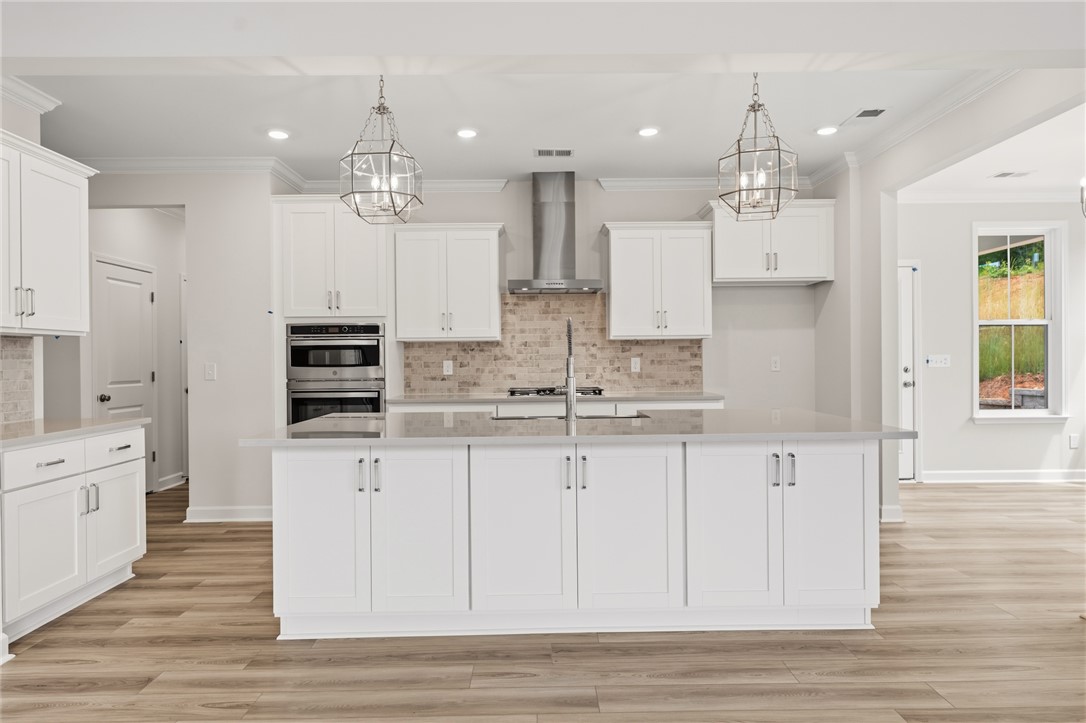 This spacious kitchen offers a central island and contemporary fixtures, perfect for daily living and entertaining.
