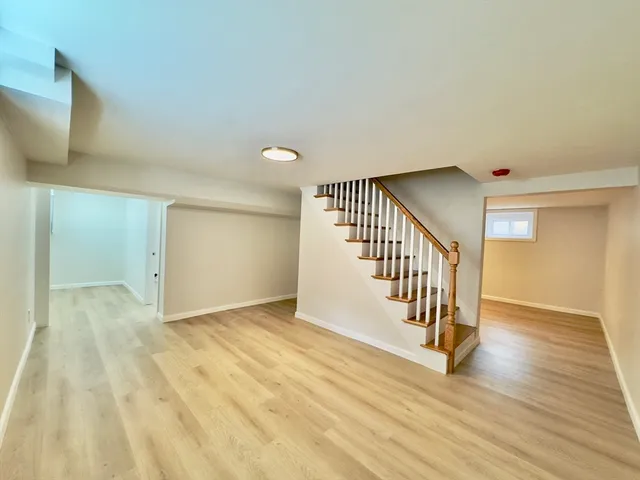 a view of an entryway with wooden floor