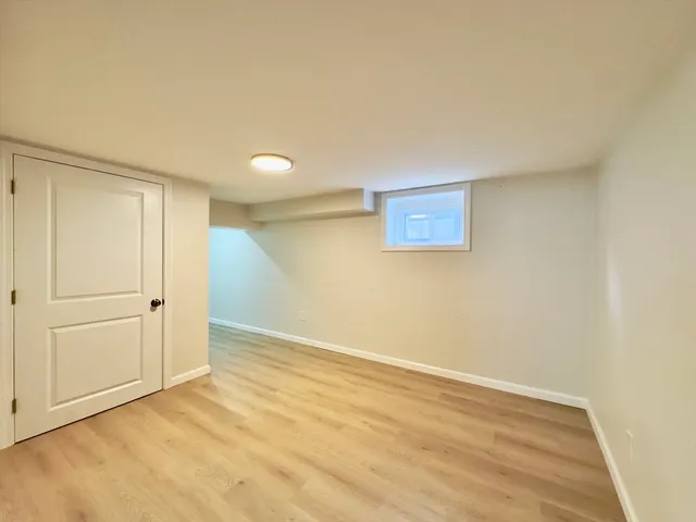 an empty room with wooden floor and closet
