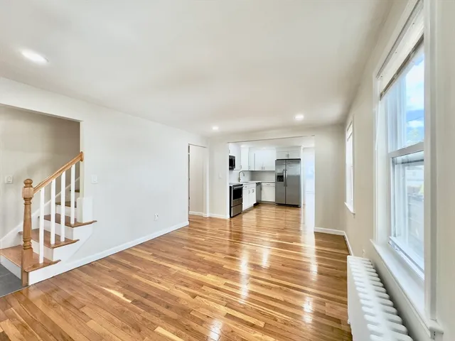 a view of a kitchen with wooden floor and a kitchen