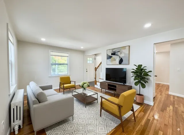 a living room with furniture and a flat screen tv