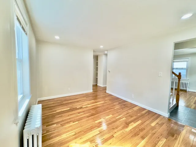 a view of an empty room and wooden floor