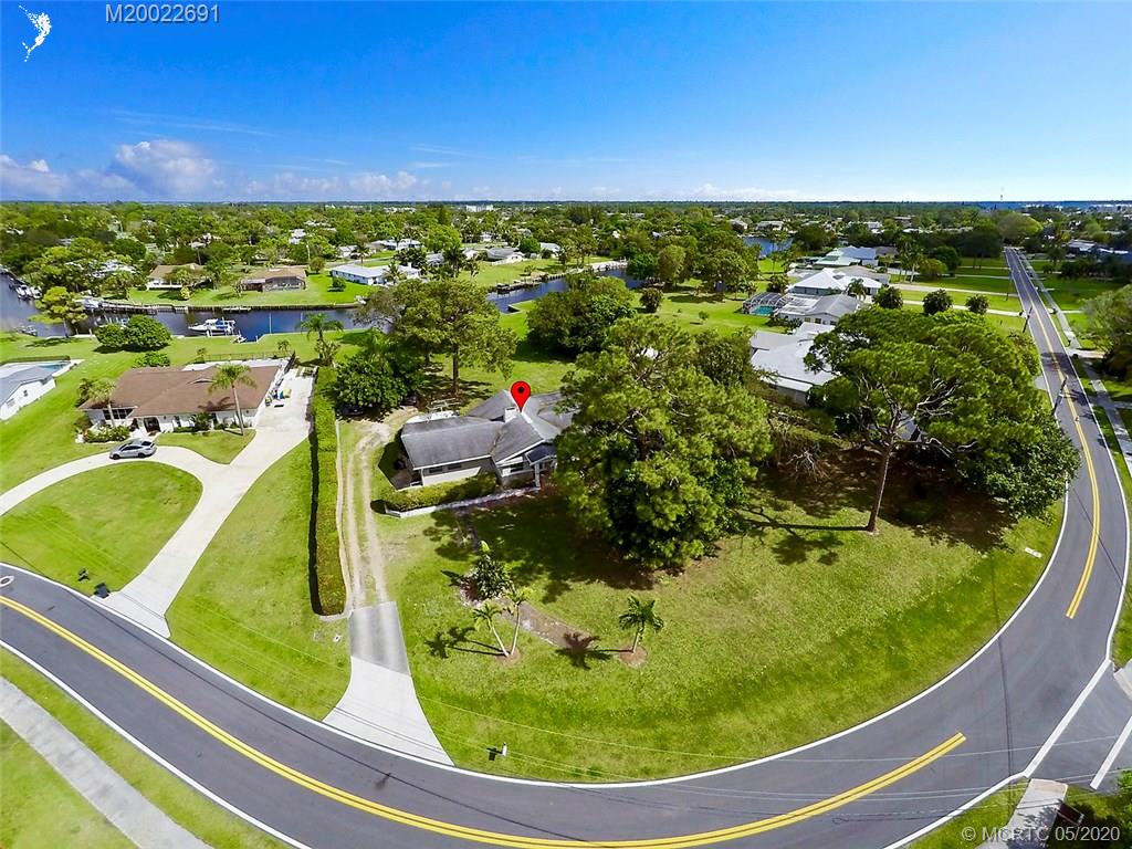 774 Northwest Spruce Ridge Drive Stuart, FL 34994 - Photo 6 of 10 a view of a swimming pool with a yard and outdoor seating
