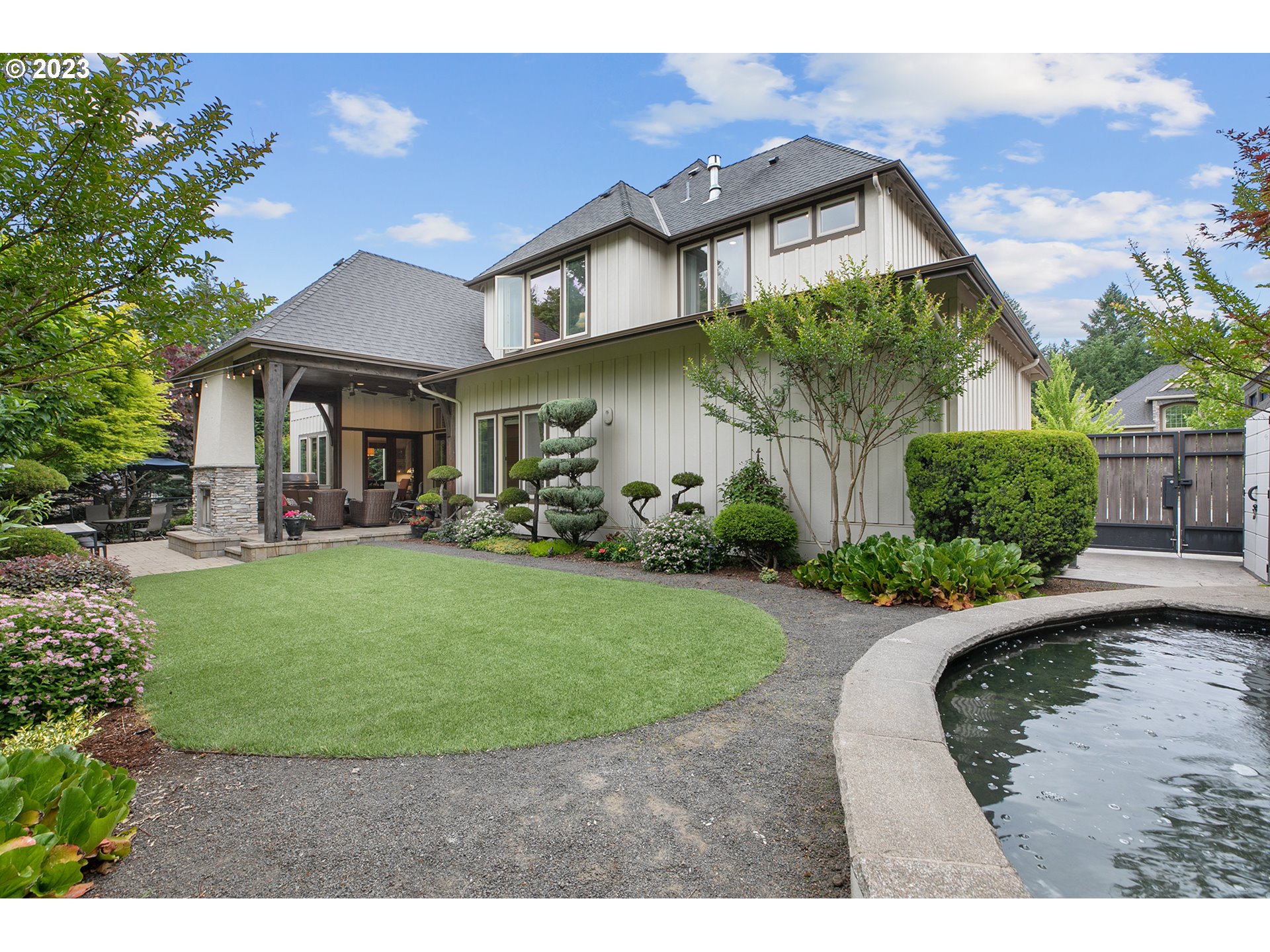 14051 155th Terrace Portland, OR 97224 - Photo 45 of 48 a view of a white house with a big yard and potted plants