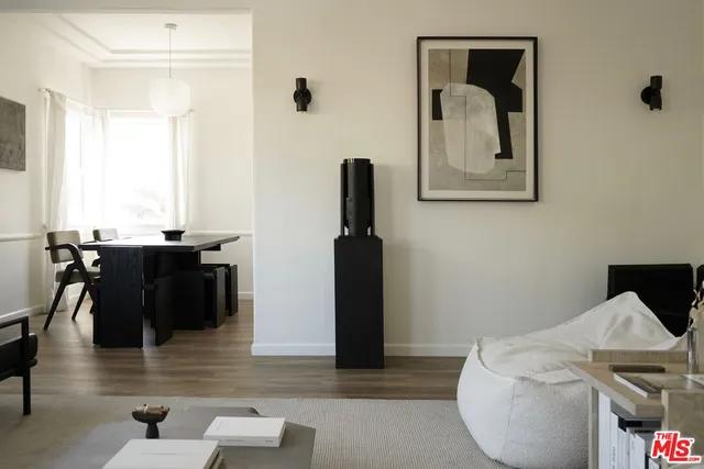 a view of a workspace with furniture and wooden floor