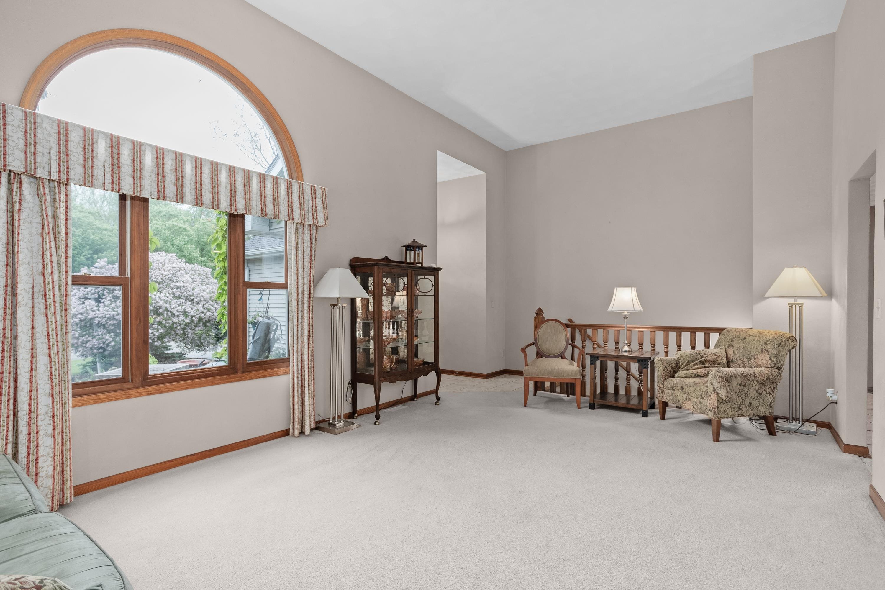 13294 Weatherfield Way Roscoe, IL 61073 - Photo 12 of 38 a view of an empty room with furniture and a window