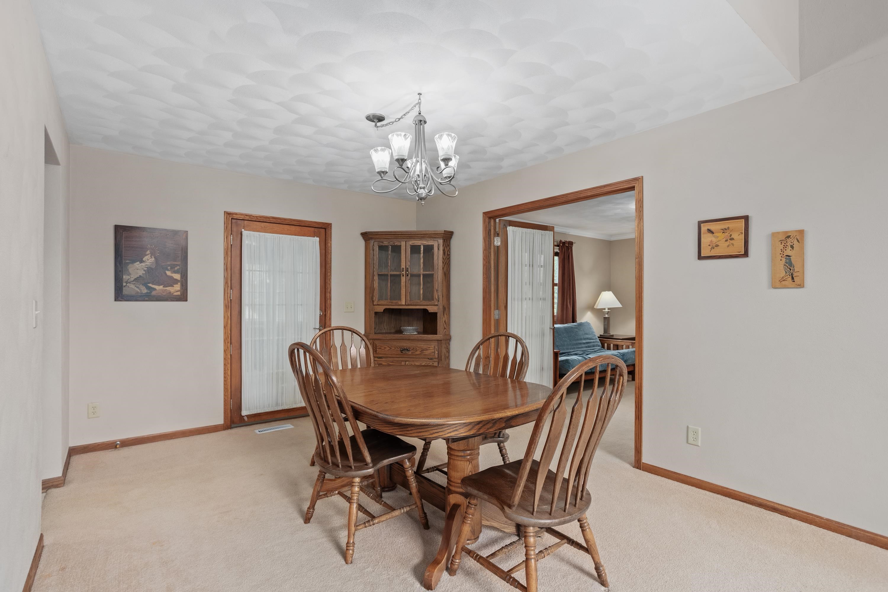 13294 Weatherfield Way Roscoe, IL 61073 - Photo 13 of 38 a view of a dining room with furniture and chandelier
