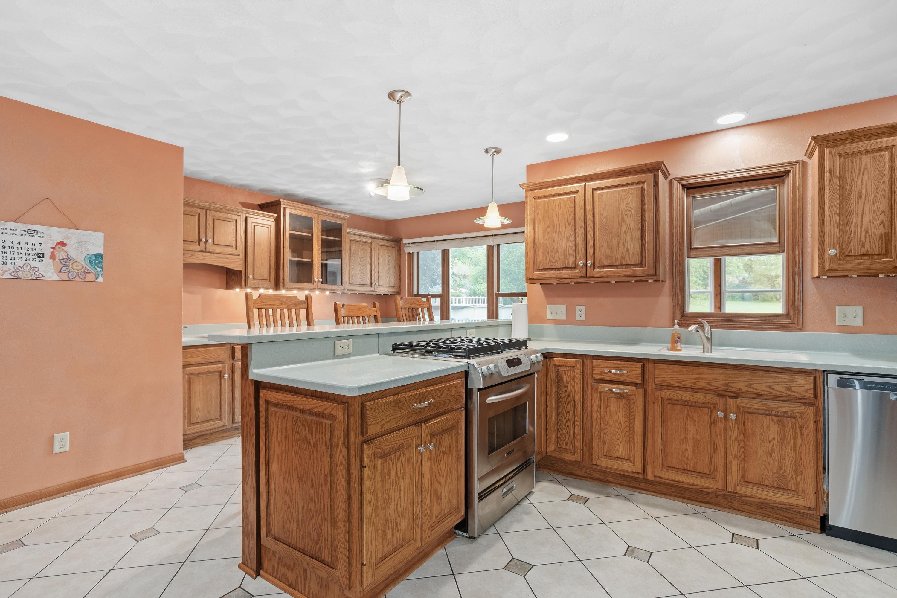13294 Weatherfield Way Roscoe, IL 61073 - Photo 19 of 38 a kitchen that has a sink and a stove in it